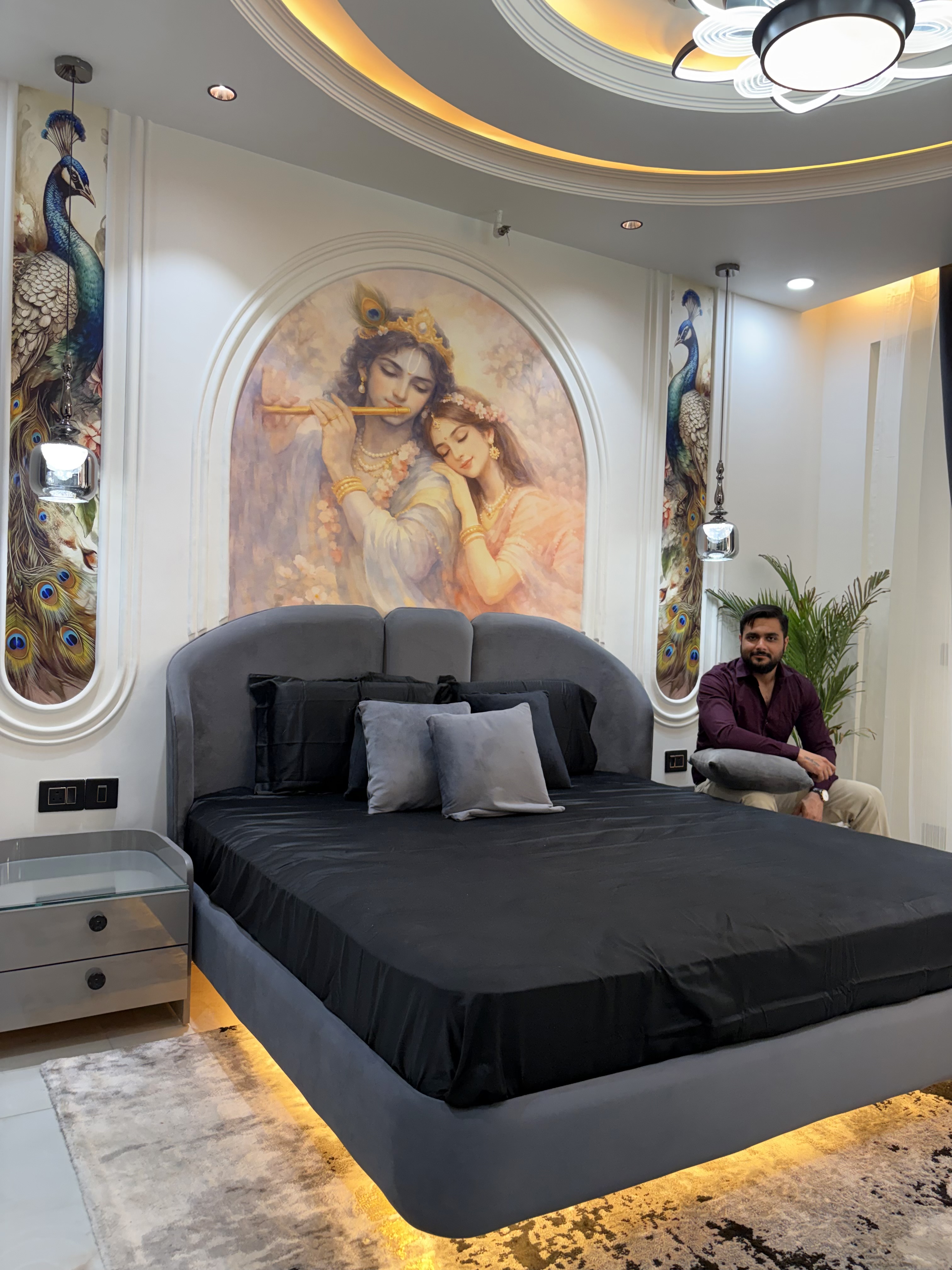 Mahagun Mascot Crossing Republic bedroom with Krishna artwork and upholstered bed