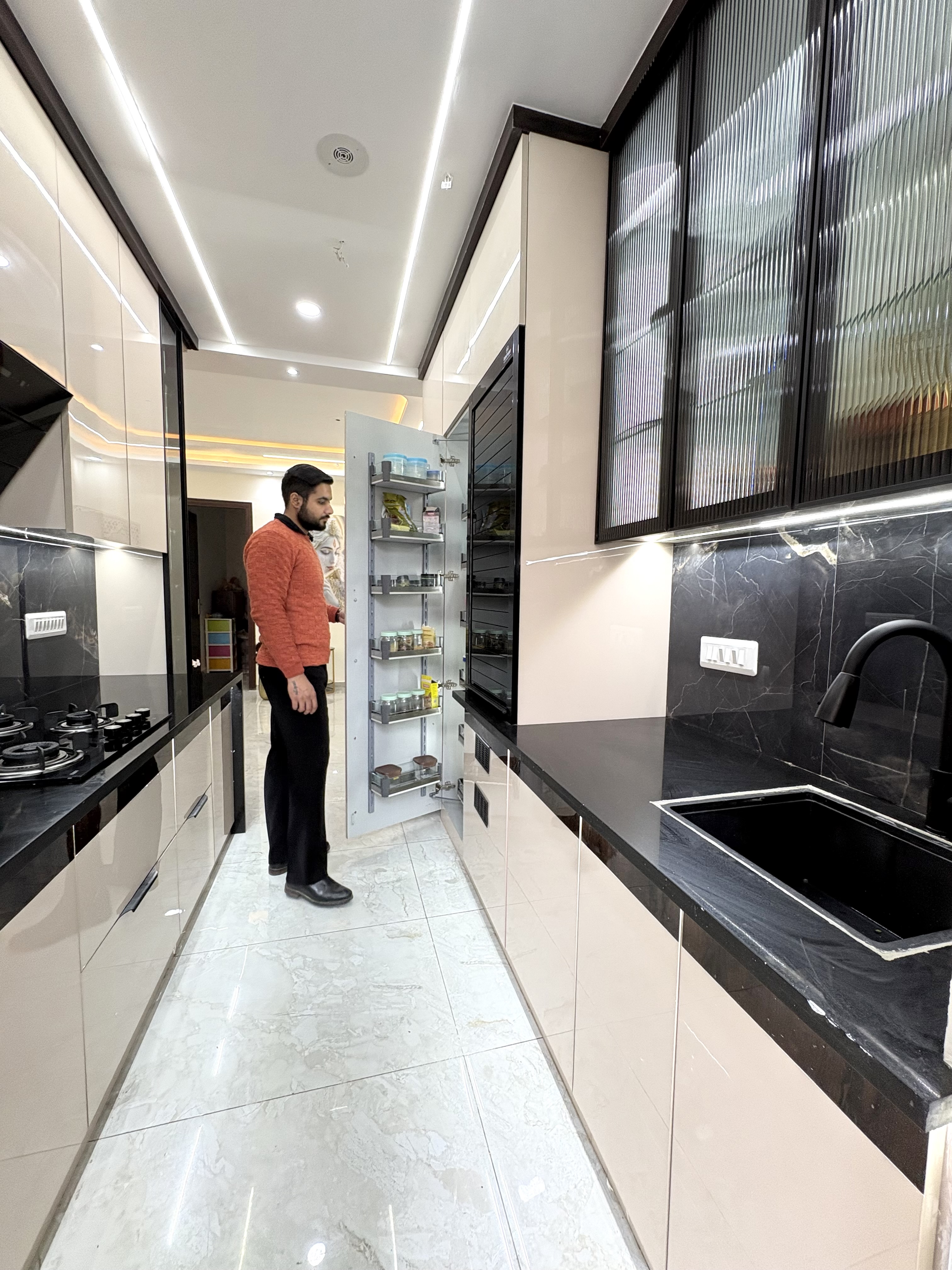 Nirala Estate kitchen with premium black stone finishes and linear lighting